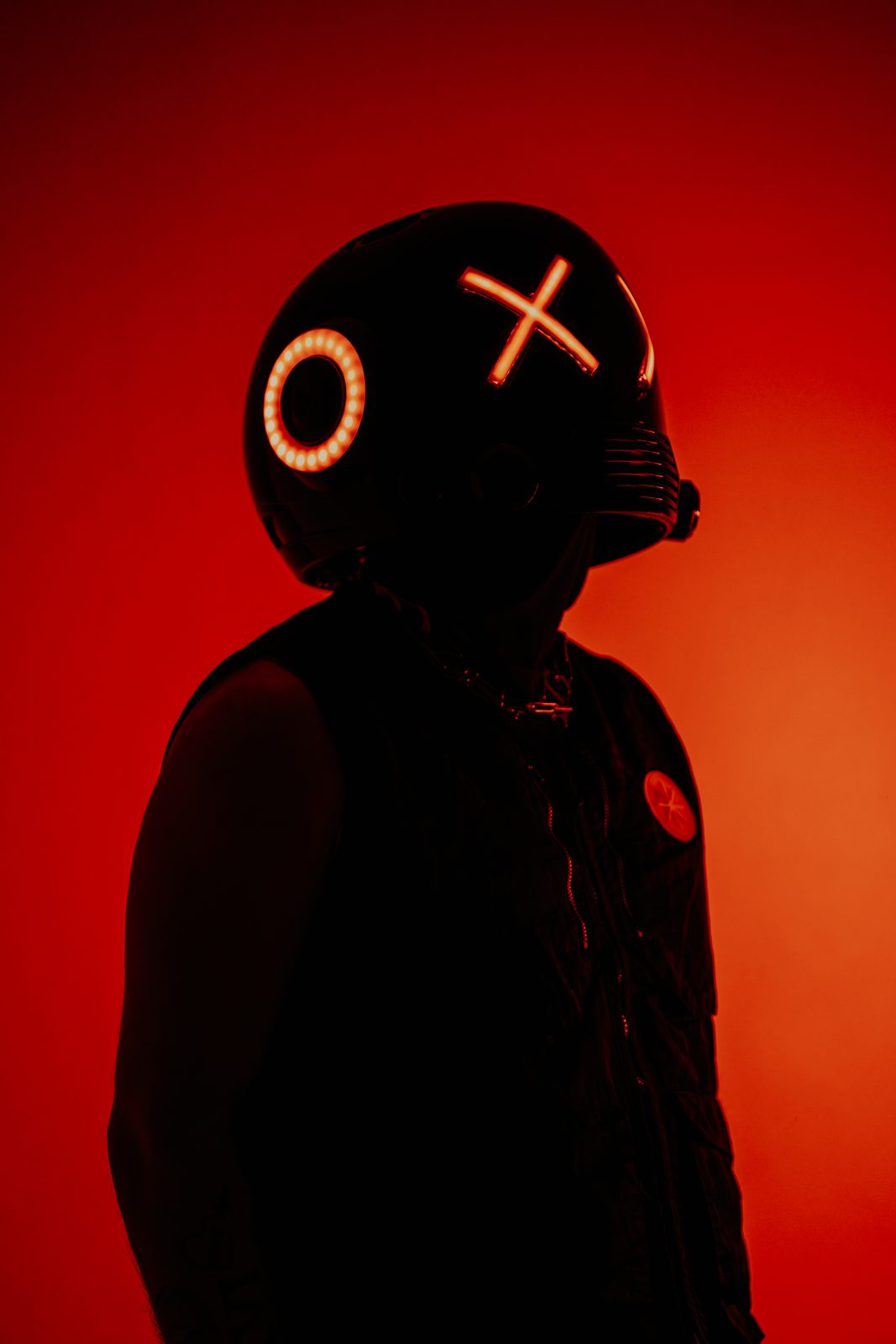Glowing helmet in profile against red