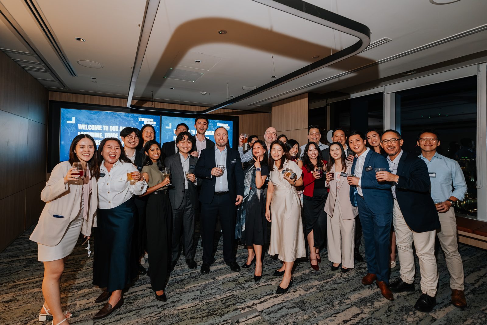Law firm team gathered for a group photo at their anniversary party