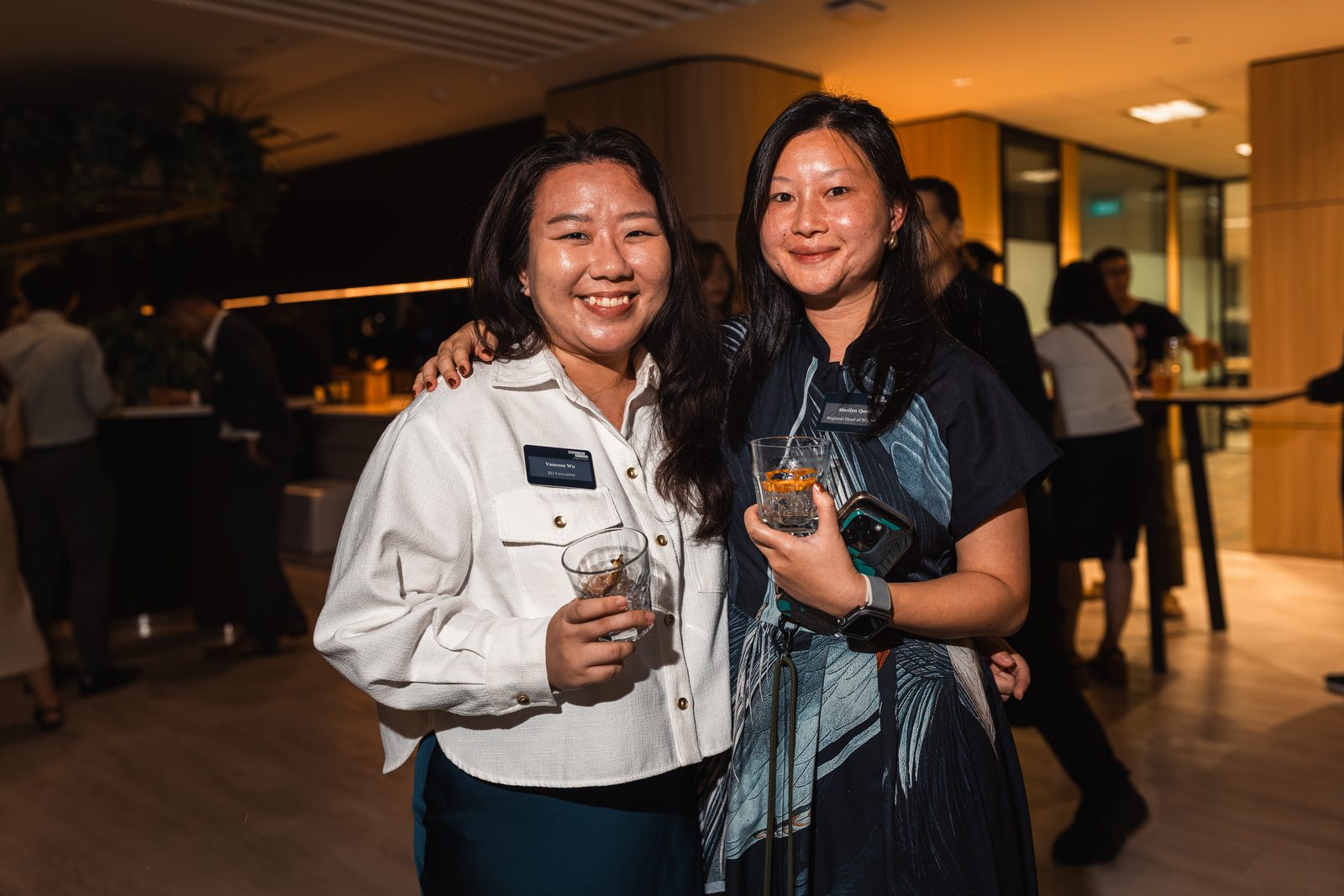 Two colleagues posing together at an evening reception