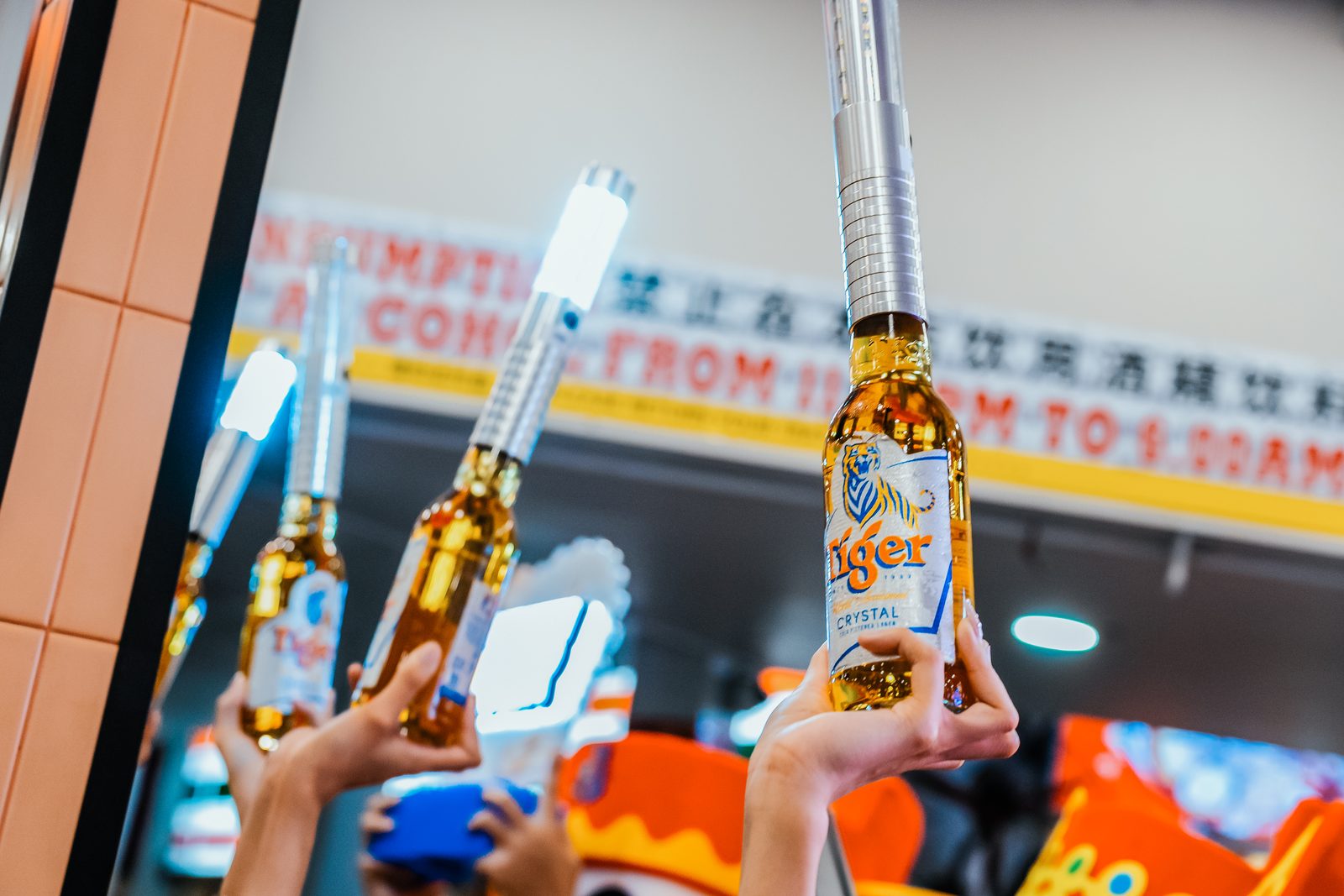 Tiger beer bottles raised high at a Lunar New Year activation