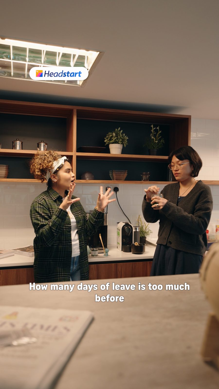 Two colleagues talking in a pantry